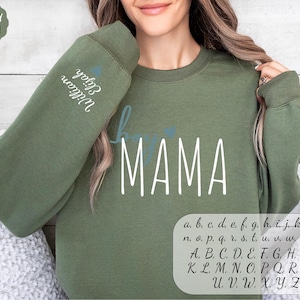 a woman wearing a sweatshirt with the word mama on it