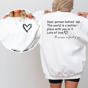 a woman wearing a sweatshirt with a quote on it