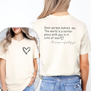 a woman wearing a t - shirt with a heart on it