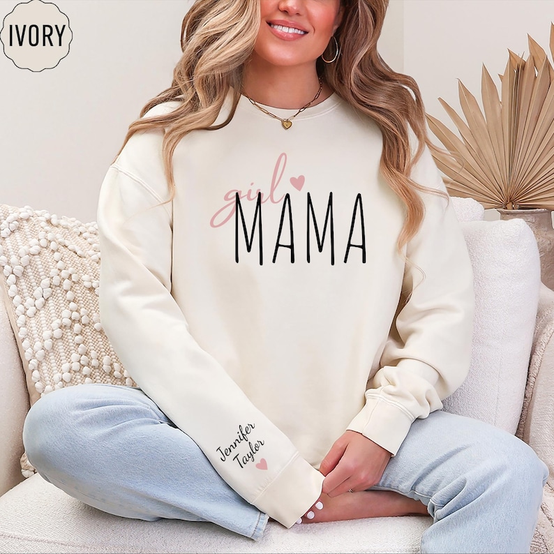 a woman sitting on a couch wearing a white sweatshirt