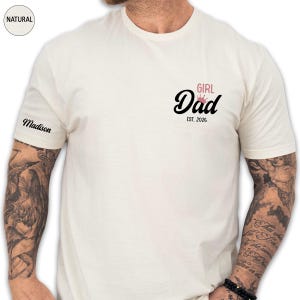 A man wearing a white t-shirt with a graphic design on the front.