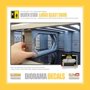 May include: A set of Death Star Large Blast Door Diorama Decals for 3.75 inch scale action figures. The decals are designed for 8.5 by 11 inch sheets. The image shows a model of a Death Star blast door with a hand holding a decal sheet.