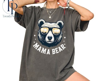 May include: A gray t-shirt with a cartoon bear wearing sunglasses and the text "Mama Bear" printed on the front.
