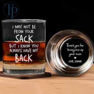 May include: A clear whiskey glass with the text "I MAY NOT BE FROM YOUR SACK BUT I KNOW YOU ALWAYS HAVE MY BACK" next to a coaster. A round glass coaster with the text "Thank you for loving me as your own LOVE, SOPHIA".