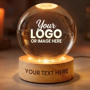 May include: A clear glass sphere lamp resting on a cylindrical light-colored wooden base. The sphere features the white text Your LOGO OR IMAGE HERE, while the wooden base displays the engraved text YOUR TEXT HERE in a dark brown font.