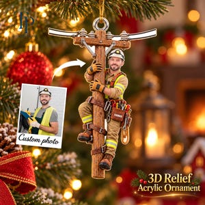 May include: A 3D relief acrylic ornament featuring a utility worker in a hard hat and high-visibility vest climbing a wooden utility pole. The worker wears a tool belt with the name Thomas printed on a pouch. A custom photo insert is included.