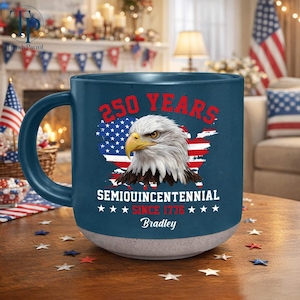 May include: A set of three ceramic mugs with a speckled, matte finish. The mugs are in shades of cream, light gray, and dark gray. Each mug has a simple, minimalist design, perfect for coffee or tea.