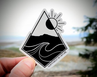 May include: Black and white sticker with a geometric design featuring a sun, a mountain, and a wave. The sticker has the text "Northwest by Nature" at the bottom.