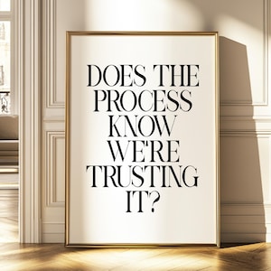 Pode incluir: Um pôster de citação motivacional em preto e branco com moldura dourada. A citação diz "Does the process know we're trusting it?"
