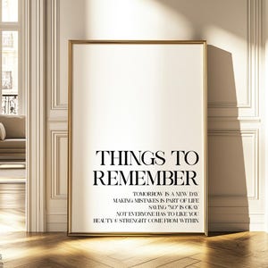May include: A framed print with a white background and black text that reads "Things to Remember" followed by a list of inspirational quotes: "Tomorrow is a new day", "Making mistakes is part of life", "Saying 'no' is okay", "Not everyone has to like you", "Beauty & Strength come from within".