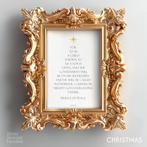 May include: A gold, elaborately decorated picture frame with a white interior. The frame contains text that reads "For to us a child is born...Prince of Peace." The word "Christmas" is at the bottom right.