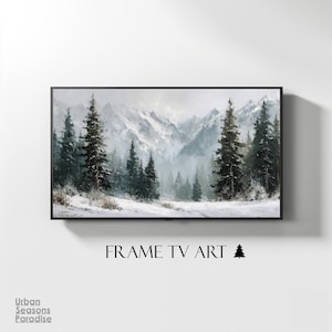 May include: A framed TV art piece featuring a winter landscape with snow-covered mountains and evergreen trees. The artwork is displayed on a white wall. The text "FRAME TV ART" is below the artwork.