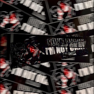 May include: A rectangular sticker featuring a black background with a glitch-effect graphic in red and white. The text reads "DON'T WORRY I'M NOT OKAY" in a bold, pixelated white font. The design is repeated in a layered, overlapping pattern.