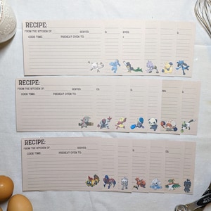 May include: Set of 12 printable recipe cards featuring Pokemon characters. Each card has a blank space for the recipe name, ingredients, instructions, and serving size. The cards are designed with a light brown background and black lines.