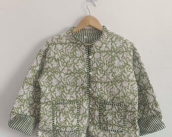 May include: A green and white floral print quilted jacket with a button closure and two patch pockets. The jacket has a mandarin collar and long sleeves with white and green striped cuffs.