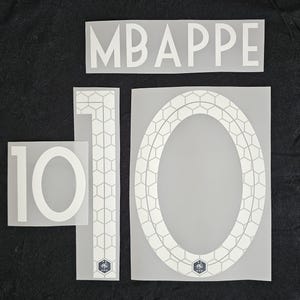 May include: White heat transfer vinyl cutouts of the name "MBAPPE" and the number "10" in various sizes. The number "10" is in a solid font and also in a honeycomb design. The French Football Federation logo is present.