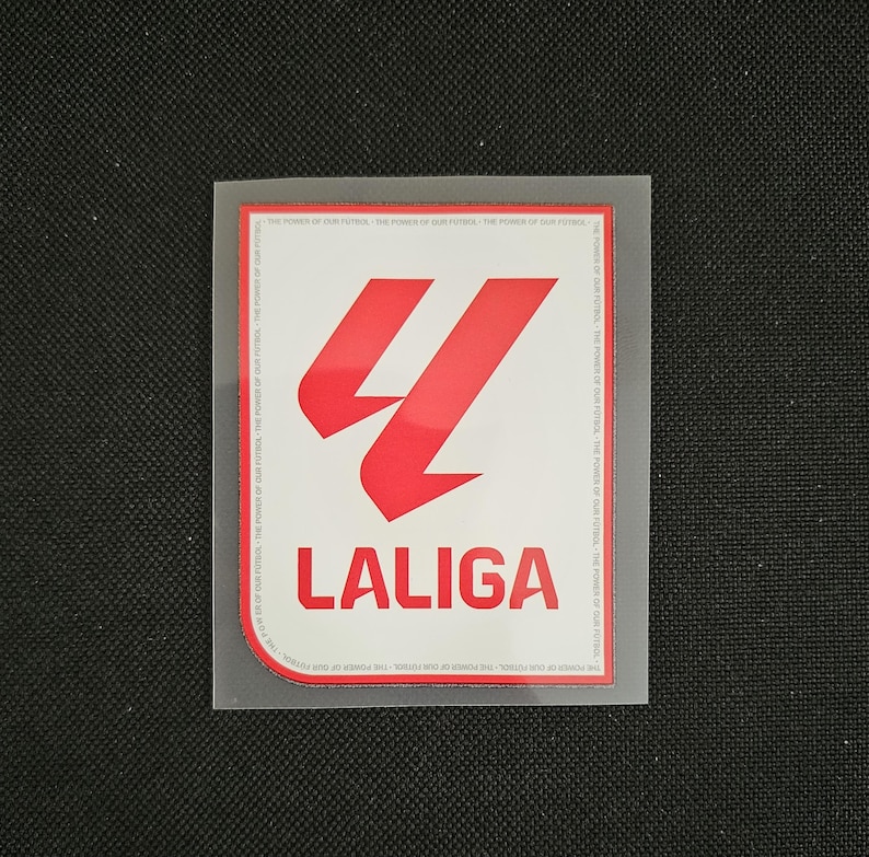 May include: A white patch with a red logo of a stylized letter "L" with the text "LALIGA" below it.
