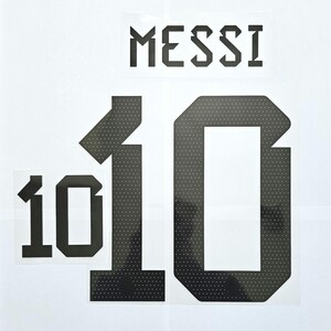 May include: Black and white iron-on numbers "10" and the word "MESSI" in a bold, blocky font. The numbers have a dotted pattern.