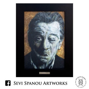 Può includere: Ritratto incorniciato di un uomo con capelli scuri e fronte aggrottata, su sfondo dorato. L'opera d'arte è racchiusa in una cornice nera. Il testo "SEVI SPANOU ARTWORKS" è visibile nella parte inferiore della cornice.
