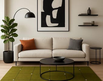 May include: A modern living room with a beige sofa, a black coffee table, and a green rug. A black and white abstract painting hangs above the sofa. A black floor lamp and a potted plant are on the left.