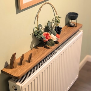 May include: A distressed wooden sign with the words "Welcome to our home" in white lettering. The sign has a rustic finish and a simple design, ideal for a hallway or porch.