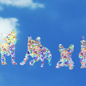May include: Four colorful, mosaic-style dog silhouettes against a bright blue sky with fluffy white clouds. The dogs are in various poses, with a vibrant, geometric pattern of colors. The overall theme is playful and artistic.
