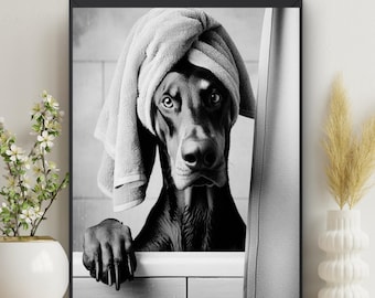 May include: Black and white photo of a dog with a towel on its head, looking out of a bathtub.