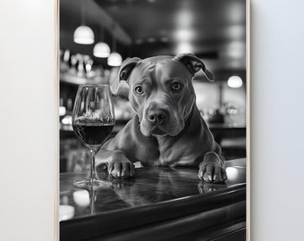 May include: A black and white photo of a pit bull dog sitting at a bar with a glass of red wine. The dog is looking directly at the camera.