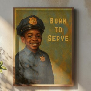 May include: A framed print featuring a smiling child in a police uniform and cap. The text "BORN TO SERVE" is displayed in gold lettering. The artwork is displayed on a wall above a wooden table with a coffee cup, saucer, and a small vase.