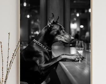 May include: Black and white photograph of a Doberman Pinscher dog sitting at a bar counter with a glass of wine. The dog is wearing a silver chain collar.