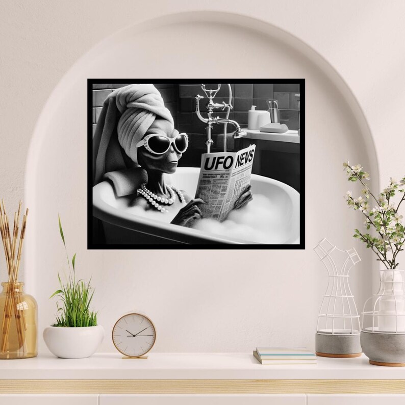 May include: A black and white photo of an alien in a bathtub reading a newspaper titled "UFO News". The alien is wearing a towel on their head and sunglasses.
