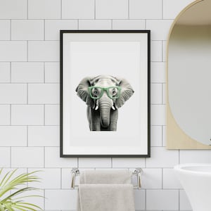 May include: A black and white illustration of an elephant wearing green glasses. The elephant is looking directly at the viewer.