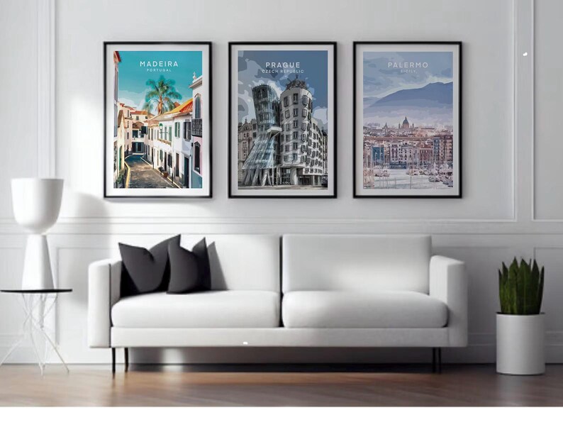 three framed pictures of different cities, including Madeira, Palermo, and Paderborn, displayed on a wall above a white sofa in a living room setting.