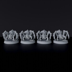 May include: Four gray, detailed, plastic spider figurines on round bases. Each spider has eight legs and a spiky, segmented body.