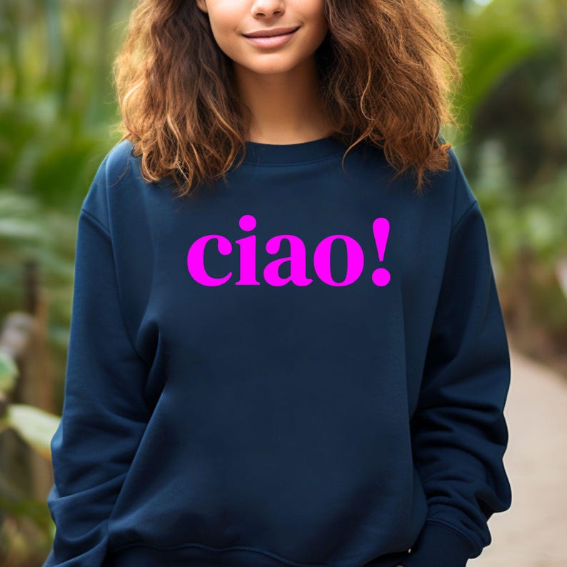 May include: A navy blue sweatshirt with the word "ciao!" printed in bright pink.