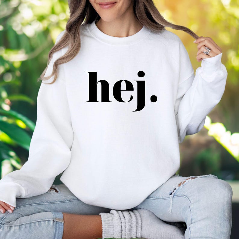 May include: White sweatshirt with black text that says "hej."
