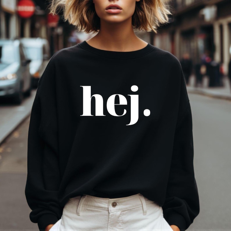 May include: Black sweatshirt with the word "hej" printed in white on the front.