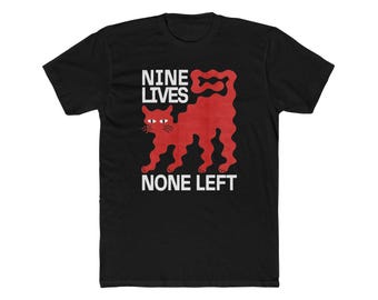 May include: Black t-shirt with a red cat graphic and the text "NINE LIVES NONE LEFT" in white. The cat design is stylized with a wavy tail and legs. A casual, graphic tee.