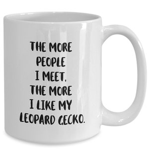 May include: White ceramic coffee mug with black text that reads "The more people I meet, the more I like my leopard gecko."