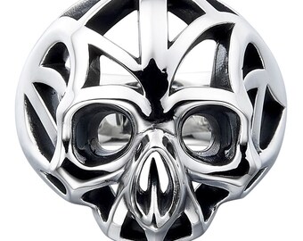 May include: A silver skull ring with a detailed, intricate design. The skull is surrounded by a cage-like structure.