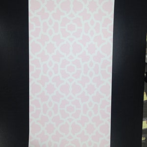 May include: A pink and white wallpaper with a geometric pattern. The pattern is made up of repeating shapes that resemble flowers or stars.