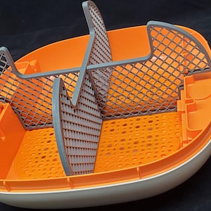 May include: Orange and gray plastic pet food container with a removable divider and a grid pattern on the bottom.