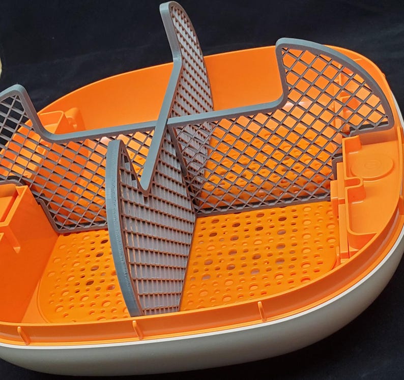 May include: Orange and gray plastic pet food container with a removable divider and a grid pattern on the bottom.