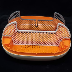 May include: A white and orange plastic litter box with two removable, gray and white mesh trays. The trays are designed to separate waste from litter.