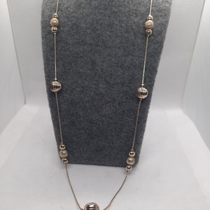 Golden textured beads on golden chain.