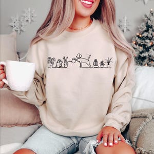 a woman sitting on a couch holding a cup of coffee