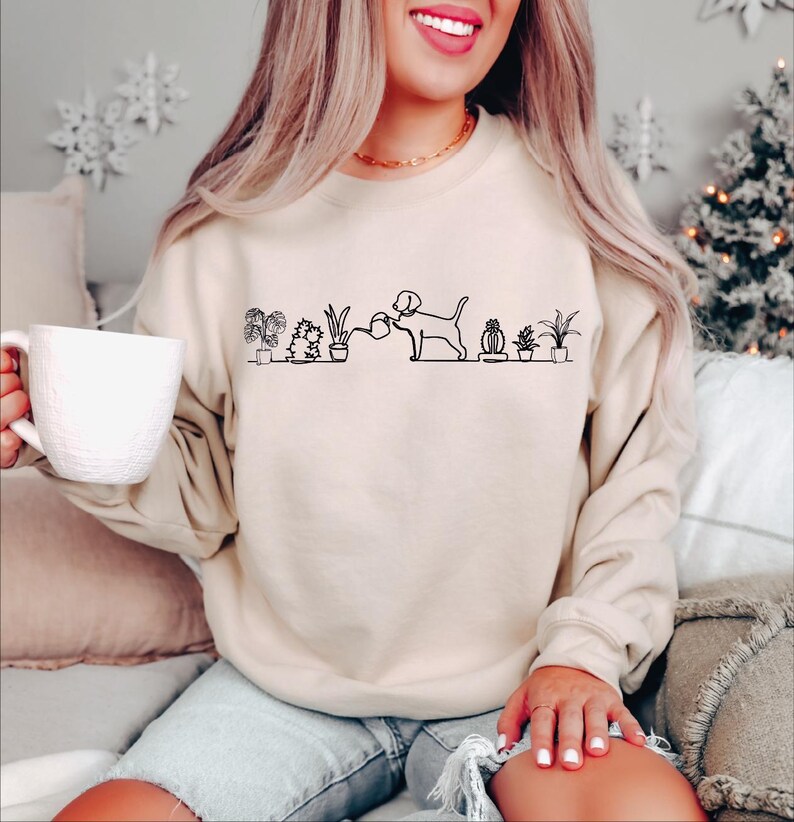 a woman sitting on a couch holding a cup of coffee