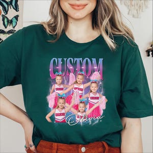 a woman wearing a green t - shirt with a picture of a group of girls