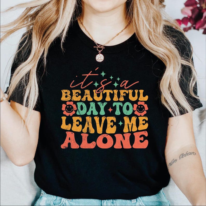 a woman wearing a t - shirt that says, it's a beautiful day