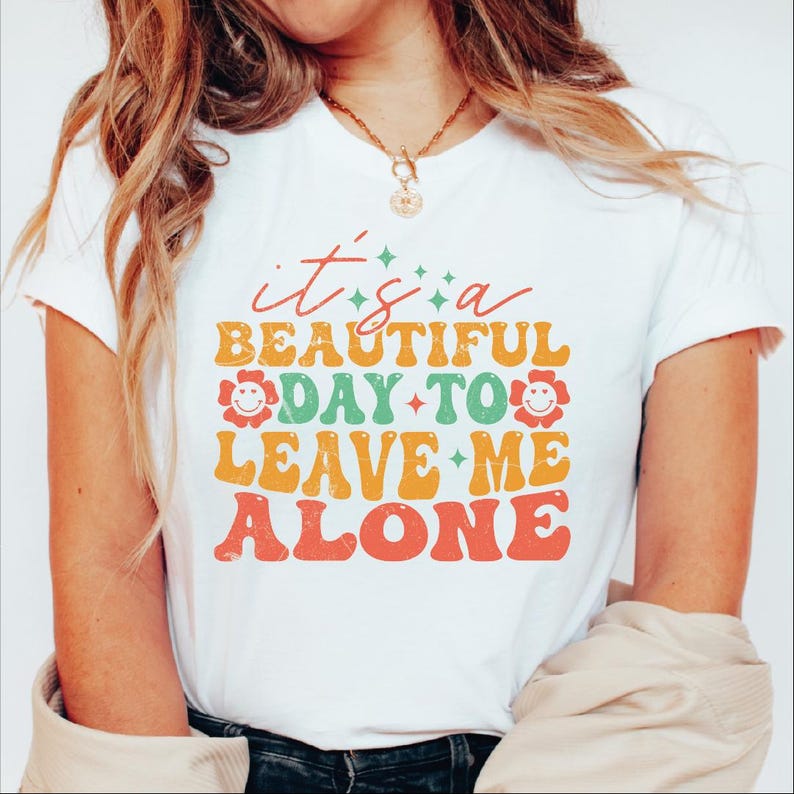 a woman wearing a t - shirt that says it's a beautiful day to